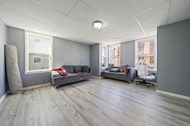48 Rocliffe St, Fall River, MA 02723 - living room featuring wood finished floors, a drop ceiling, and baseboards
