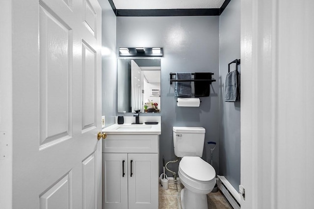 98 Eastern Ave Unit 403, Worcester, MA 01605 - bathroom with baseboard heating, toilet, vanity, baseboards, and tile patterned flooring