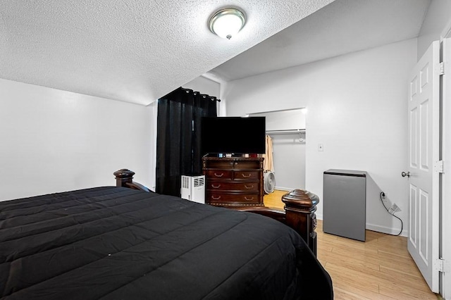 98 Eastern Ave Unit 403, Worcester, MA 01605 - bedroom with light wood-style floors, a textured ceiling, and baseboards