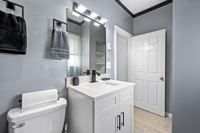 98 Eastern Ave Unit 403, Worcester, MA 01605 - half bathroom featuring toilet, vanity, tile patterned floors, and ornamental molding