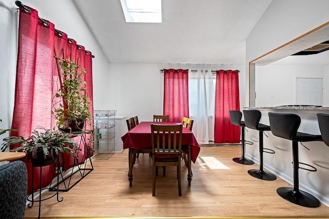 98 Eastern Ave Unit 403, Worcester, MA 01605 - dining space featuring light wood-type flooring, lofted ceiling, and a skylight