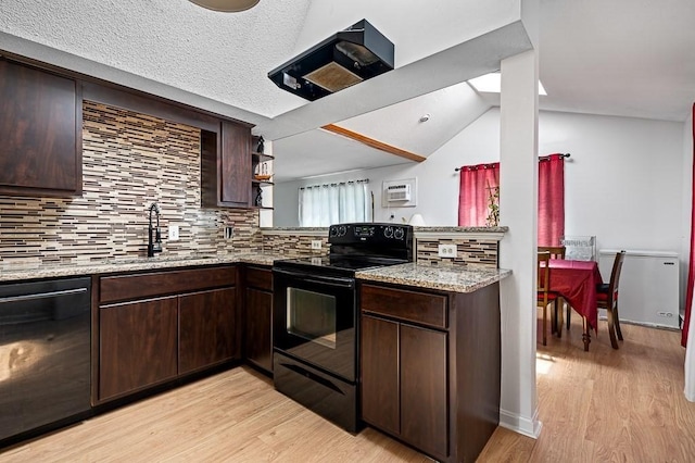 98 Eastern Ave Unit 403, Worcester, MA 01605 - kitchen with black appliances, a sink, dark brown cabinets, tasteful backsplash, and vaulted ceiling