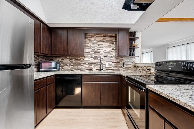 98 Eastern Ave Unit 403, Worcester, MA 01605 - kitchen with black appliances, a sink, light wood finished floors, dark brown cabinets, and tasteful backsplash