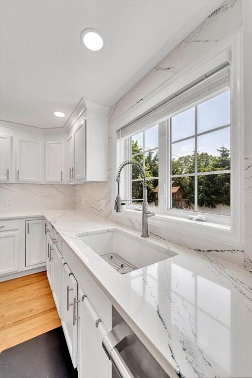 47 Fenwick Cir, Methuen, MA 01844 - kitchen featuring white cabinetry, recessed lighting, light stone counters, tasteful backsplash, and light wood finished floors