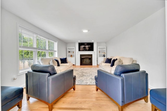 47 Fenwick Cir, Methuen, MA 01844 - living area featuring a glass covered fireplace and light wood finished floors