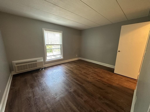 147 Turner Rd Unit 102, Holliston, MA 01746 - spare room featuring an AC wall unit and dark wood-type flooring