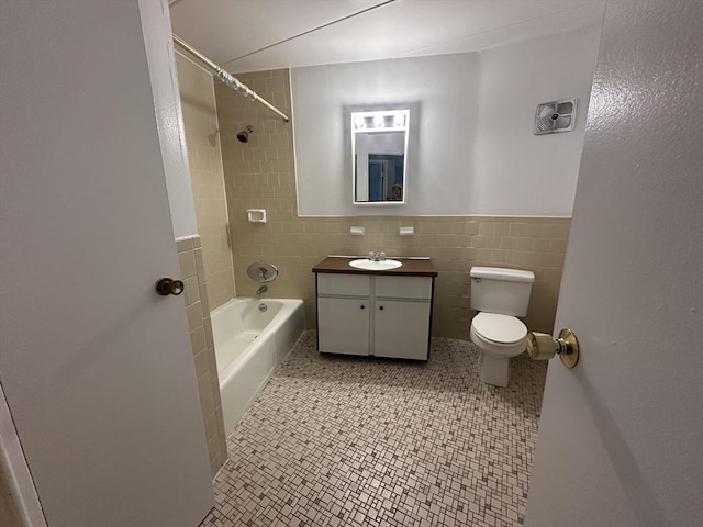 147 Turner Rd Unit 102, Holliston, MA 01746 - bathroom with vanity, tile walls, washtub / shower combination, and a wainscoted wall
