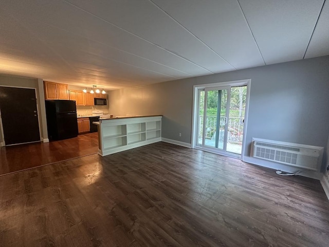 147 Turner Rd Unit 102, Holliston, MA 01746 - unfurnished living room featuring dark wood-style flooring and a wall mounted air conditioner