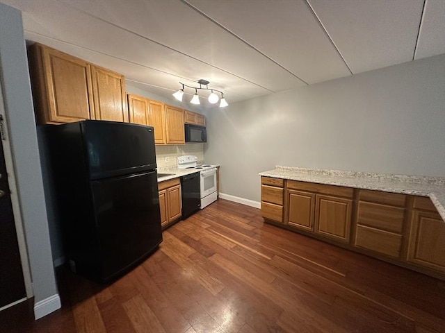 147 Turner Rd Unit 102, Holliston, MA 01746 - kitchen with black appliances, dark wood-style flooring, light countertops, and decorative backsplash