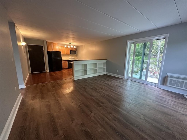 147 Turner Rd Unit 102, Holliston, MA 01746 - unfurnished living room featuring a wall mounted AC and dark wood-style floors