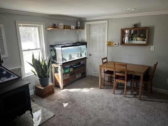 dining space featuring baseboards, carpet floors, and ornamental molding