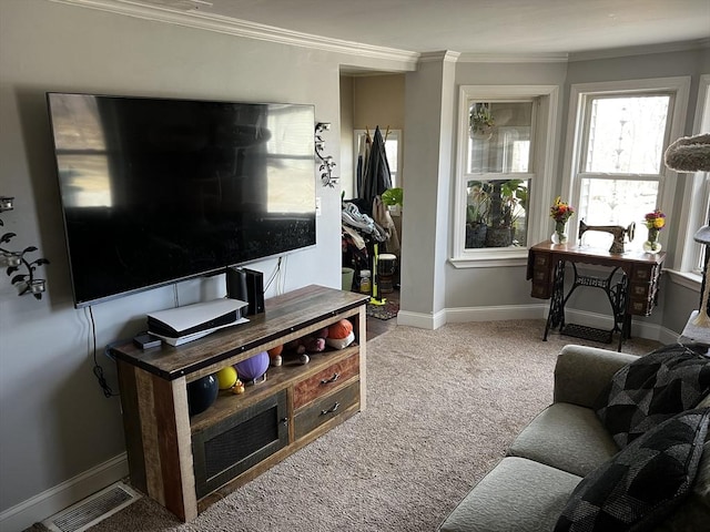 carpeted living room featuring visible vents, baseboards, and ornamental molding