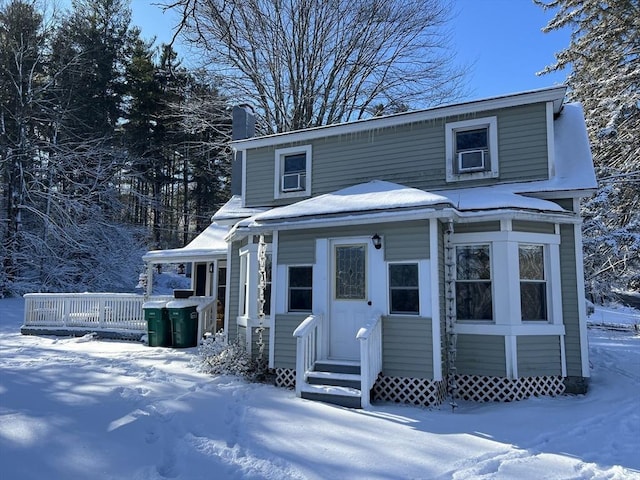 view of front of house with entry steps and a chimney