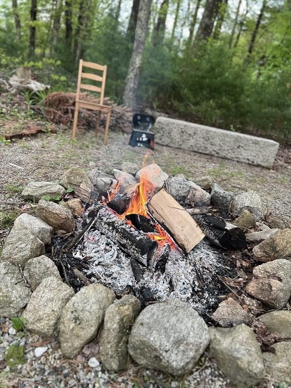 view of yard with an outdoor fire pit