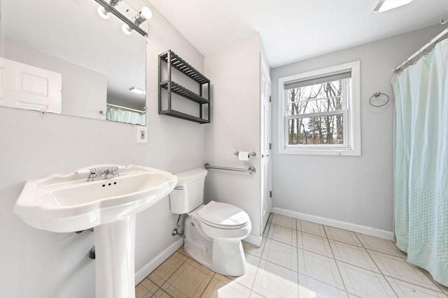 full bathroom featuring tile patterned floors, toilet, and baseboards