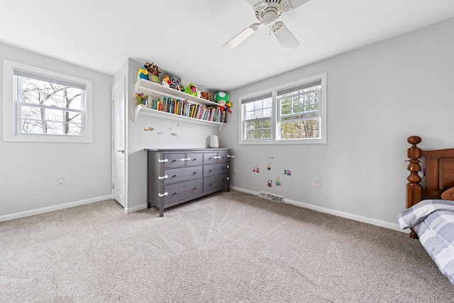 bedroom featuring visible vents, light carpet, baseboards, and ceiling fan