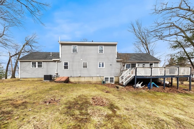 back of property featuring a yard, central AC unit, a deck, and a shingled roof