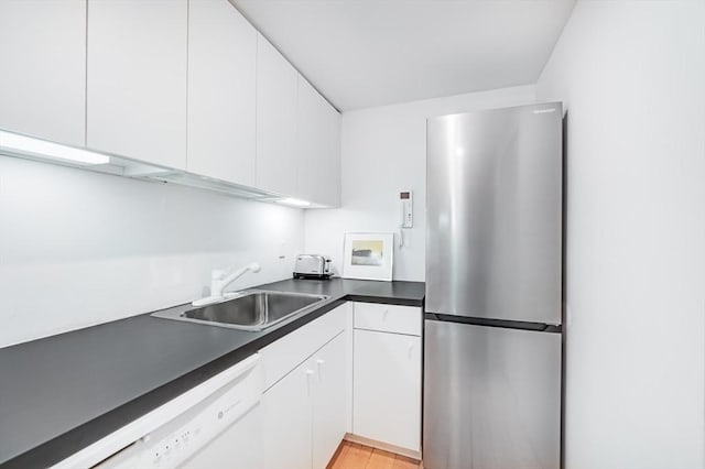 175 Commonwealth Ave Unit A, Boston, MA 02116 - kitchen with freestanding refrigerator, white dishwasher, a sink, white cabinets, and dark countertops