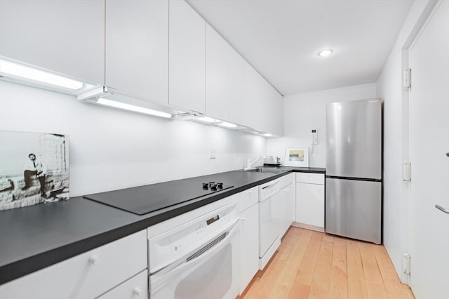 175 Commonwealth Ave Unit A, Boston, MA 02116 - kitchen featuring white appliances, white cabinetry, dark countertops, light wood-style flooring, and a sink