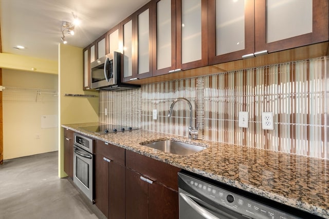 kitchen featuring dark brown cabinetry, light stone countertops, sink, stainless steel appliances, and tasteful backsplash