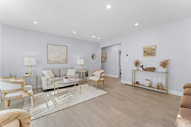 living area with recessed lighting, baseboards, and wood finished floors