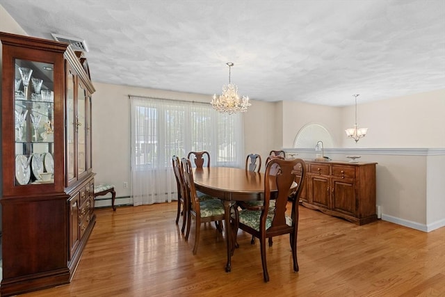 171 Taft Rd, Wilmington, MA 01887 - dining room with a chandelier, a baseboard heating unit, light wood-type flooring, and a textured ceiling