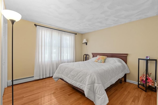 171 Taft Rd, Wilmington, MA 01887 - bedroom featuring a baseboard radiator and wood finished floors
