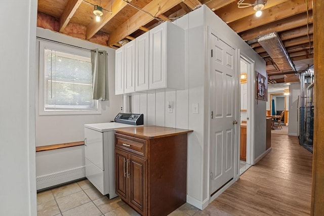 171 Taft Rd, Wilmington, MA 01887 - laundry area featuring a baseboard heating unit, cabinet space, and light wood-type flooring