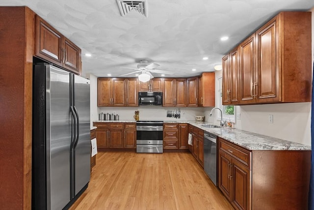 171 Taft Rd, Wilmington, MA 01887 - kitchen featuring appliances with stainless steel finishes, brown cabinets, recessed lighting, light wood-style flooring, and ceiling fan