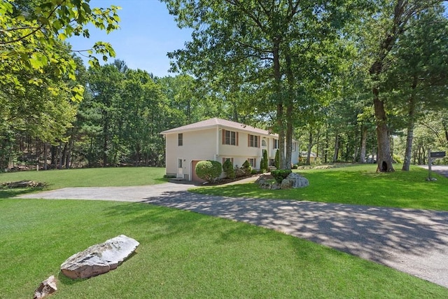 171 Taft Rd, Wilmington, MA 01887 - view of front of house featuring driveway, a front lawn, and an attached garage