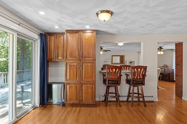 171 Taft Rd, Wilmington, MA 01887 - kitchen featuring ceiling fan, brown cabinetry, light wood-style floors, and recessed lighting