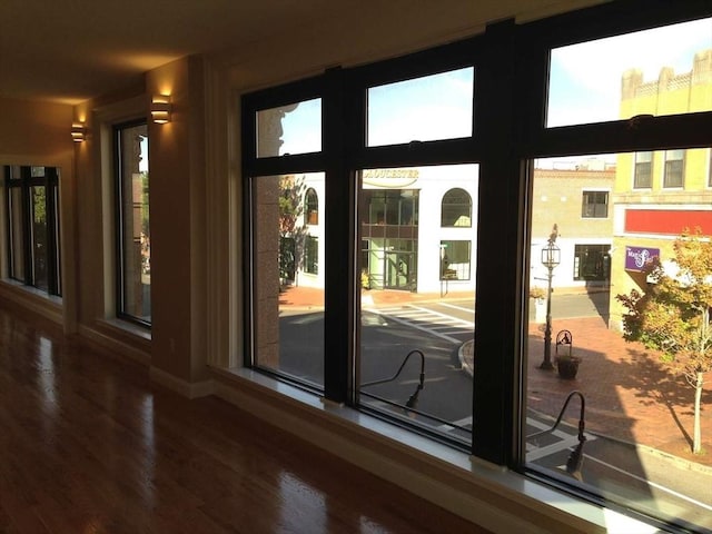doorway to outside featuring wood finished floors and baseboards