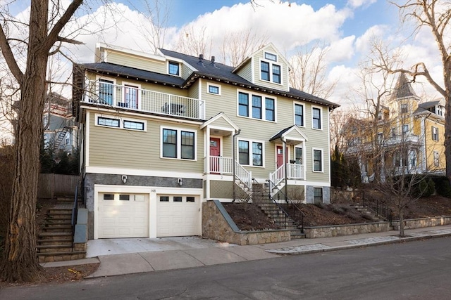 view of front of house with a garage and a balcony