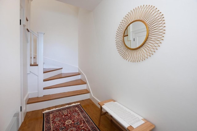 stairs with hardwood / wood-style floors