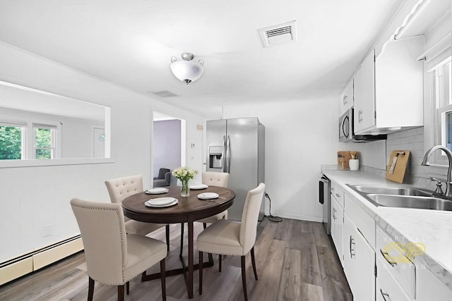101 Alpha St, Dartmouth, MA 02747 - dining space with baseboard heating and wood finished floors