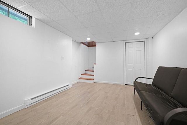 101 Alpha St, Dartmouth, MA 02747 - living area with a baseboard heating unit, light wood-style floors, a drop ceiling, recessed lighting, and stairs