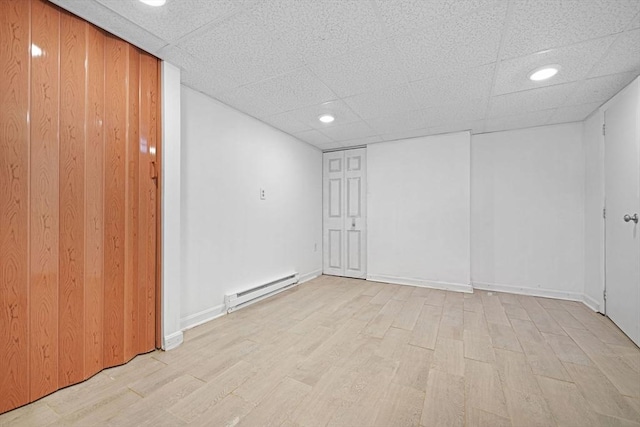 101 Alpha St, Dartmouth, MA 02747 - unfurnished room featuring baseboard heating, light wood-style floors, a drop ceiling, recessed lighting, and baseboards