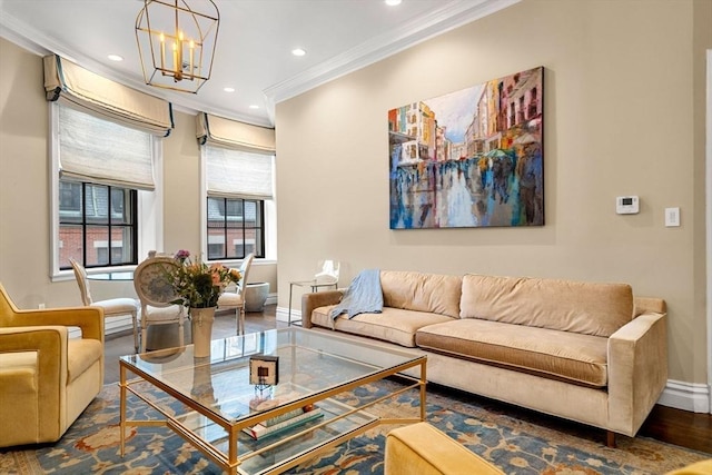 living room with an inviting chandelier, recessed lighting, baseboards, and ornamental molding