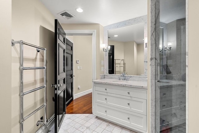 bathroom with visible vents, a shower with door, recessed lighting, baseboards, and vanity