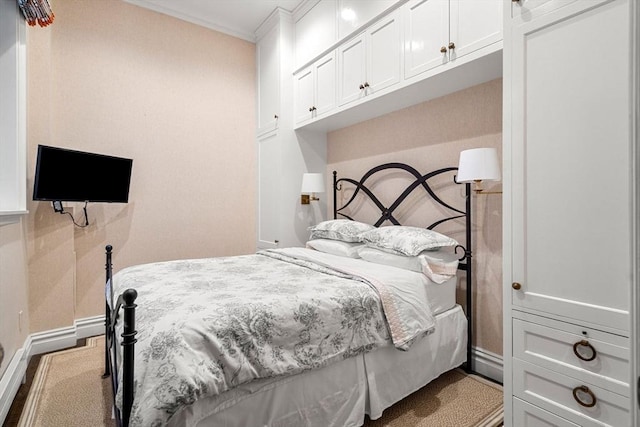 bedroom featuring baseboards and crown molding