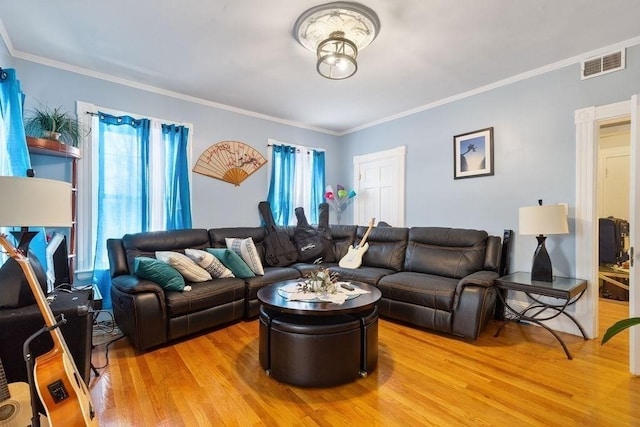 living room with hardwood / wood-style flooring and ornamental molding