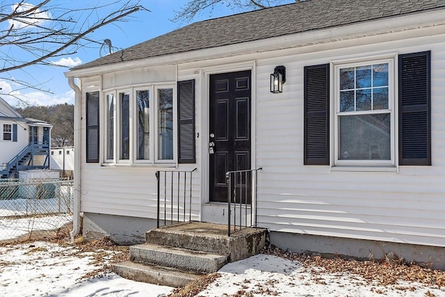 view of snow covered property entrance