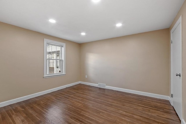 empty room featuring dark wood-type flooring