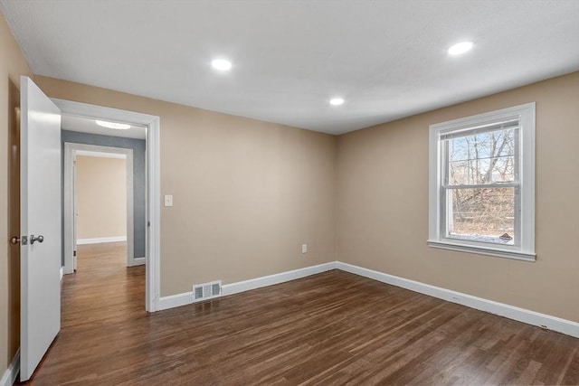 spare room with dark hardwood / wood-style floors