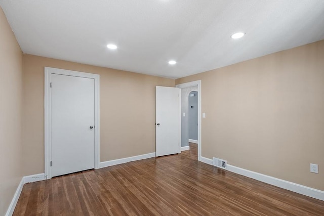 empty room with hardwood / wood-style flooring