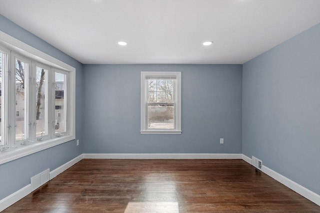 empty room with dark hardwood / wood-style floors