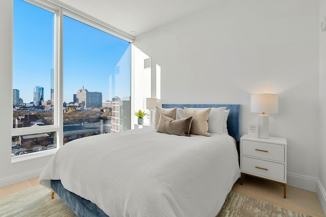 bedroom featuring light hardwood / wood-style floors and multiple windows