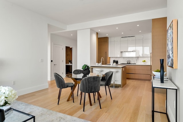 dining space with light wood-type flooring