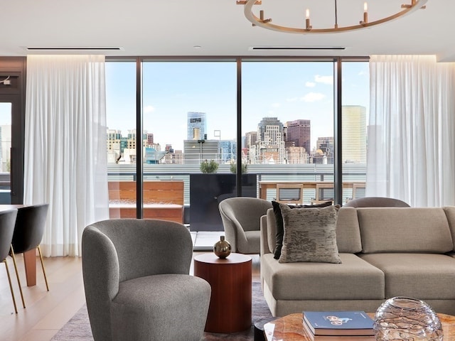 living room with wood-type flooring, expansive windows, and a notable chandelier