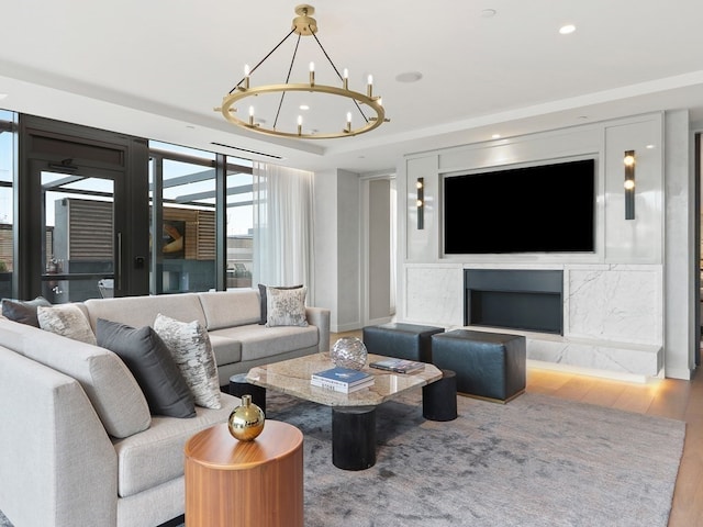 living room with a high end fireplace and wood-type flooring